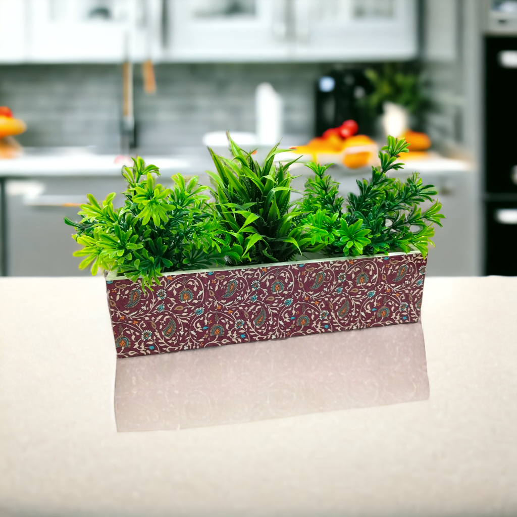 Decorative planter with green plants on a kitchen counter