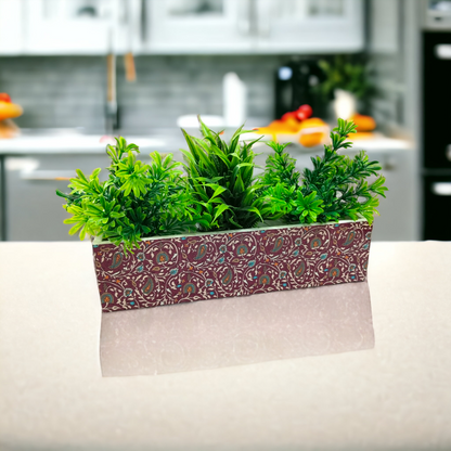 Decorative planter with green plants on a kitchen counter